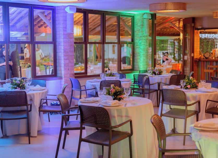 Sobrado da Vila Hotel in Mata de São João dining room with set tables and colorful lighting
