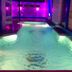 Al Nabarees Al Masi Hotel, Jeddah: indoor pool with purple lighting and lounge area