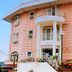 Resort Inn Marion Shinano in Hakuba, pink hotel exterior with balcony and white columns