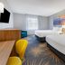 Days Inn Roanoke Near I-81 in Roanoke: guest room with two beds, desk and mountain sunset wall art