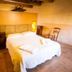 Agriturismo Il Casale Degli Amici in Norcia bedroom with double bed, wood beams, and rustic decor