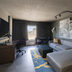 Bally's Baton Rouge Hotel suite with gray sectional, desk, and city view window
