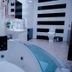 Tyco City Hotel, Sunyani: bathroom with corner whirlpool tub, sink, toilet and tiled floor