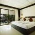 Bamboo Beach Hotel & Spa in Patong, guest room with king bed and pool view through sliding doors