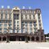 Shell House Hotel in Baoding, a grand multi-story hotel building with arched windows and balconies.