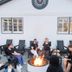 The Waypoint, Rehoboth Beach: guests seated around a fire pit on the patio outside the hotel