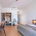Kaliviani Traditional Hotel in Kissamos: guest room with bed, desk, wall-mounted TV, and open wardrobe