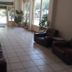 Nestor hotel lobby in Zacháro with leather chairs, potted plants, and bright glass entrance