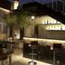 Yogi Executive, Navi Mumbai bar lounge with stools, tables, lit shelves and staircase