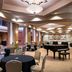 The Lincoln Marriott Cornhusker Hotel in Lincoln event ballroom with grand piano, round tables and patterned ceiling lights