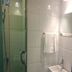 Atour Hotel Dalian Zhongshan Plaza bathroom with glass shower and wall-mounted sink in Dalian