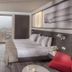 Inntu Hotel Medellín guest room with king bed, floor-to-ceiling window and city view