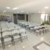 Hotel Armonía Hostal in San Salvador event room with rows of white folding chairs and a small table