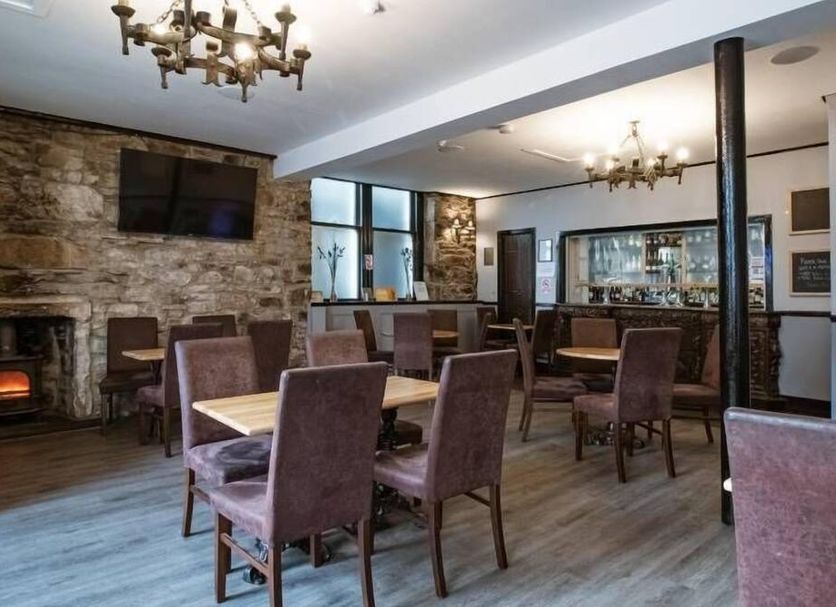 Ben Mhor Hotel in Grantown-on-Spey lounge with stone fireplace, dining tables and bar area