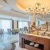 Breakfast buffet at Riviera Rayhaan by Rotana Doha in Doha with chandelier-lit dining area