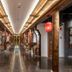 Grand Pacific Hotel Ningbo hallway with carved wooden columns, red lantern lights, and polished floor in Ningbo