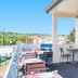 Campanile Melun Sud - Dammarie les Lys terrace with tables and chairs, overlooking nearby rooftops