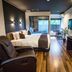 Livemax Resort Hakone Ashinoko room with king bed, recliner, desk and balcony view in Hakone