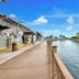 Quayside Hotel Malacca waterfront boardwalk beside a canal with riverside buildings and blue sky