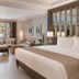 Henann Regency Resort & Spa Boracay guest room with king bed, seating area and balcony view