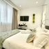 Le Muraine in Bergamo guest room with king bed, wall-mounted TV, and window with sheer curtains