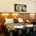 Central Motel Mildura room with double bed, sofa, and window with curtains in Mildura