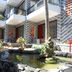 Palmira Beach Resort & Spa in Phan Thiet, courtyard with pond, palm trees, and balconies