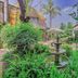 Sunward Park Guest House & Conference Centre, Boksburg: lush garden courtyard with tiered fountain and seating