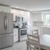 935 Ocean, a Beachside Inn in Hampton: bright kitchen with stainless steel appliances and dining table