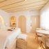 Donatella Boutique Hotel Miami Beach guest room with king bed, arched headboard niche and seating area