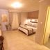 Hotel Mallas in Nea Kallikratia guest room with double bed, tiled floor, vanity, and bathroom doorway