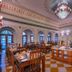 The Tigress, Ranthambore restaurant with chandeliers, checkered floor, and set dining tables