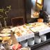 SL'otel Budget Bernburg breakfast buffet with pastries, fruit, plates, and serving dishes