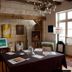 La Demeure Saint-Ours in Loches: art display room with easels, framed paintings and a table