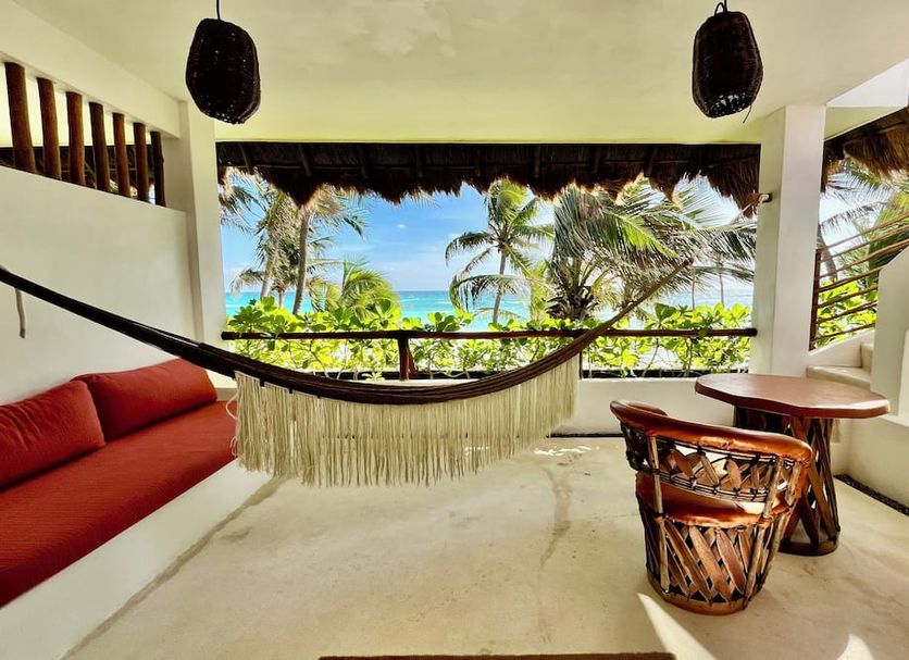The Beach Tulum Hotel in Tulum: hammock lounge with ocean view, palm trees and outdoor seating