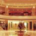 Chinflux Mandarin Hotel in Dongguan lobby with grand columns, mezzanine balconies, and central fountain