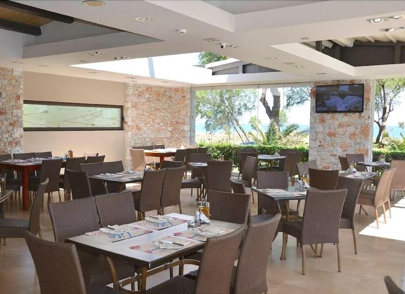Lito Beach Hotel in Gerani outdoor restaurant with tables, chairs and sea views