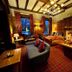 The Upper House, Stoke-on-Trent: cozy lounge with fireplace, leather seating, wood paneling, and plaid carpet