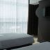 Grand Orchid Hotel Yogyakarta room with two beds and floor-to-ceiling window in Depok