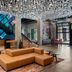 The Gordon Hotel in Eugene lobby with a geometric sofa, colorful rug, and sparkling ceiling installation