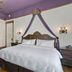 Patterson Inn Denver guest room with canopy bed and fireplace
