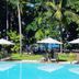 Iara Beach Hotel Boutique in Salvador with outdoor pool, loungers and palm trees near the beach