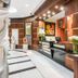 GH Galeria in Guayaquil lobby reception with wood paneling, black front desk, and floral arrangements
