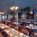 Hotel du Vin Henley in Henley-on-Thames dining room with set tables, leather banquette and hanging plants