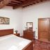 Borgo Nuovo San Martino bedroom in Ambra with wood ceiling, double bed, and terracotta tile floor