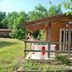 Lagrange Vacances Les Ségalières in Gramat, wooden cabin with porch and outdoor seating in greenery