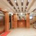 Hotel Shreesu Kathmandu lobby with brick walls, elevator, seating area, and reception desk