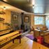Sunapee Lake Lodge in Newbury: rustic lounge with wood stove, sofas, game table and lake-view window