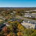 Aerial view of Quality Inn Wayne - Fairfield Area in Wayne surrounded by fall foliage and nearby roads