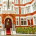 Althoff St James's Hotel & Club London in London, red-brick facade with flower-covered entrance and red carpet